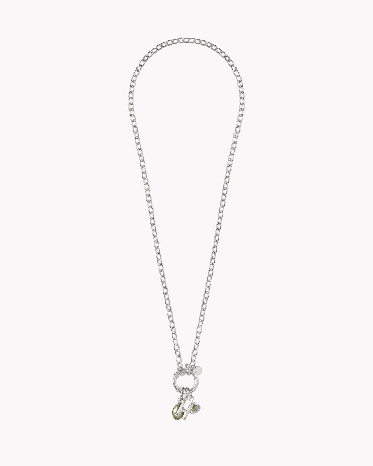 Close-up of alphabet charm on the St Géran sterling silver necklace