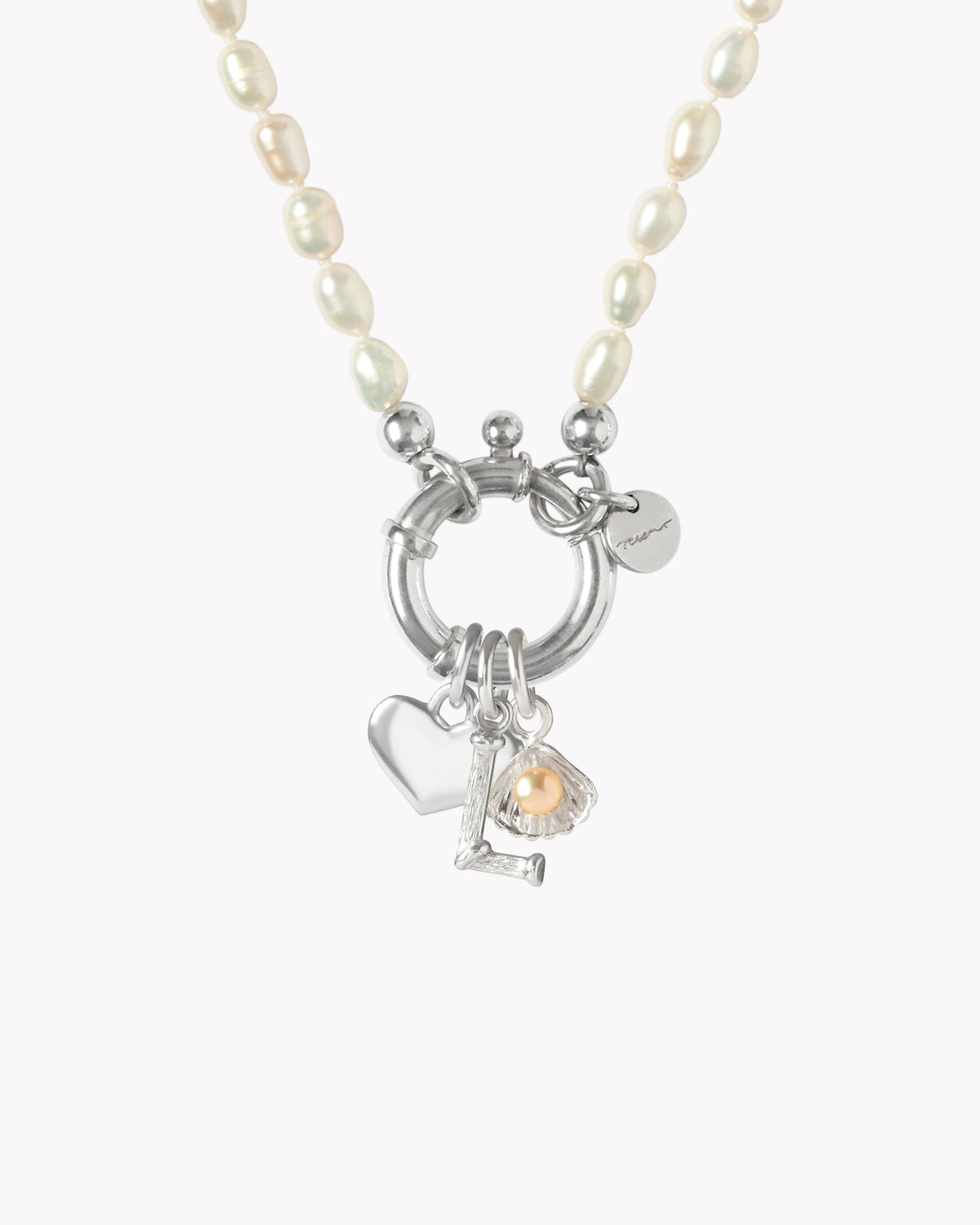 Close-up of Surinam sterling silver necklace with white freshwater pearls and personalised charms