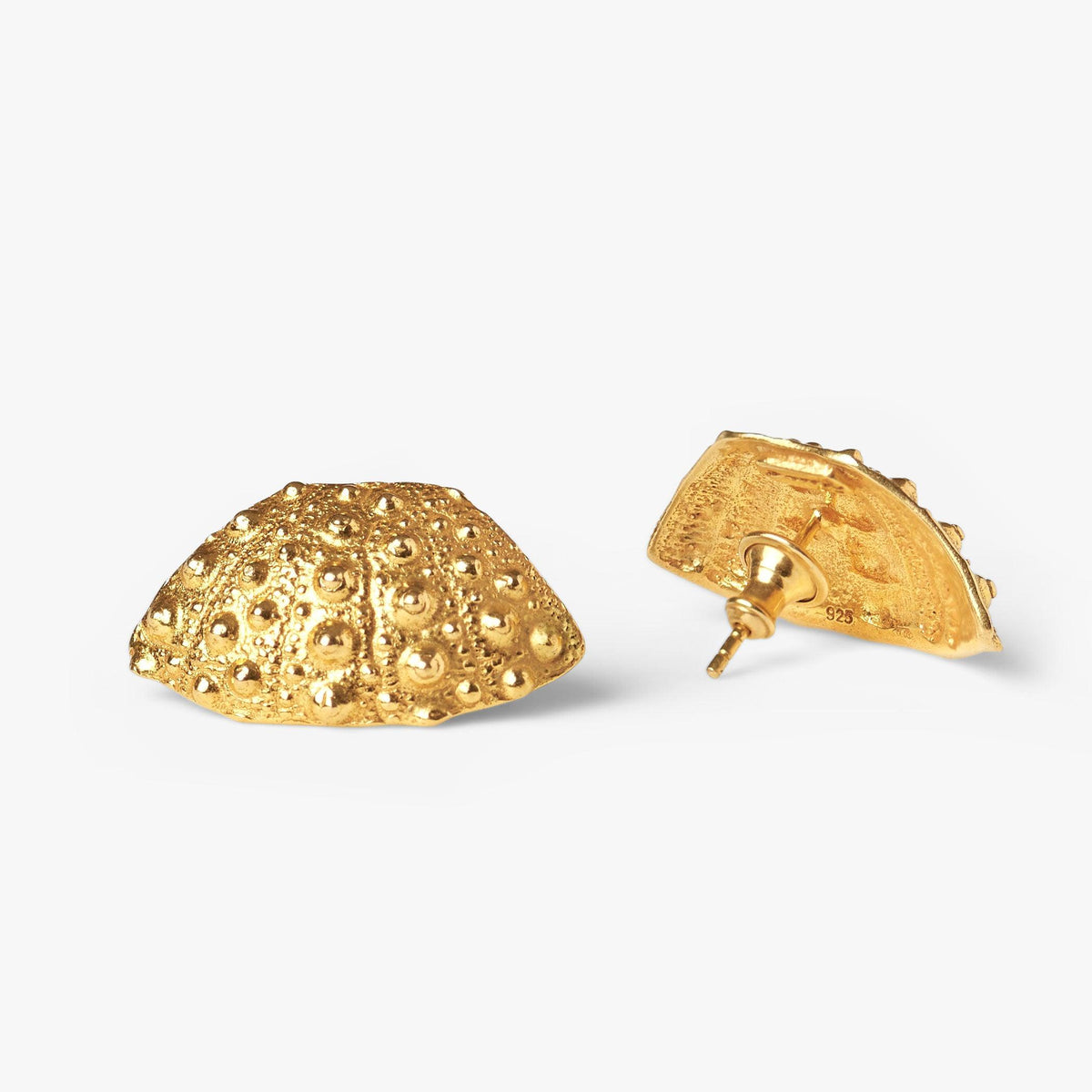 Close-up of Grand Gaube gold vermeil earrings with a sea urchin-inspired ocean design
