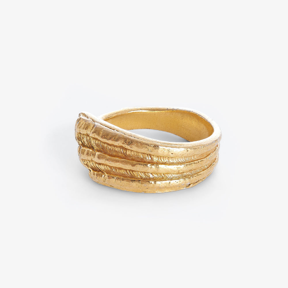 Side view of the Riambel Gold ring showing its sculpted textured wave design