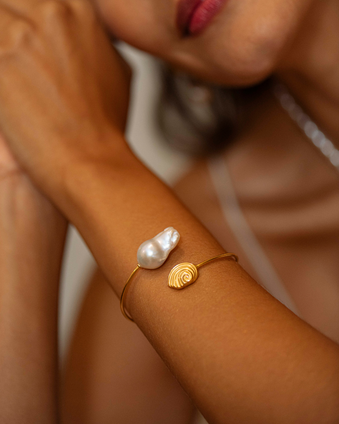 Trou d'Eau Douce gold spiral bracelet featuring a natural baroque pearl by Oceano Jewels