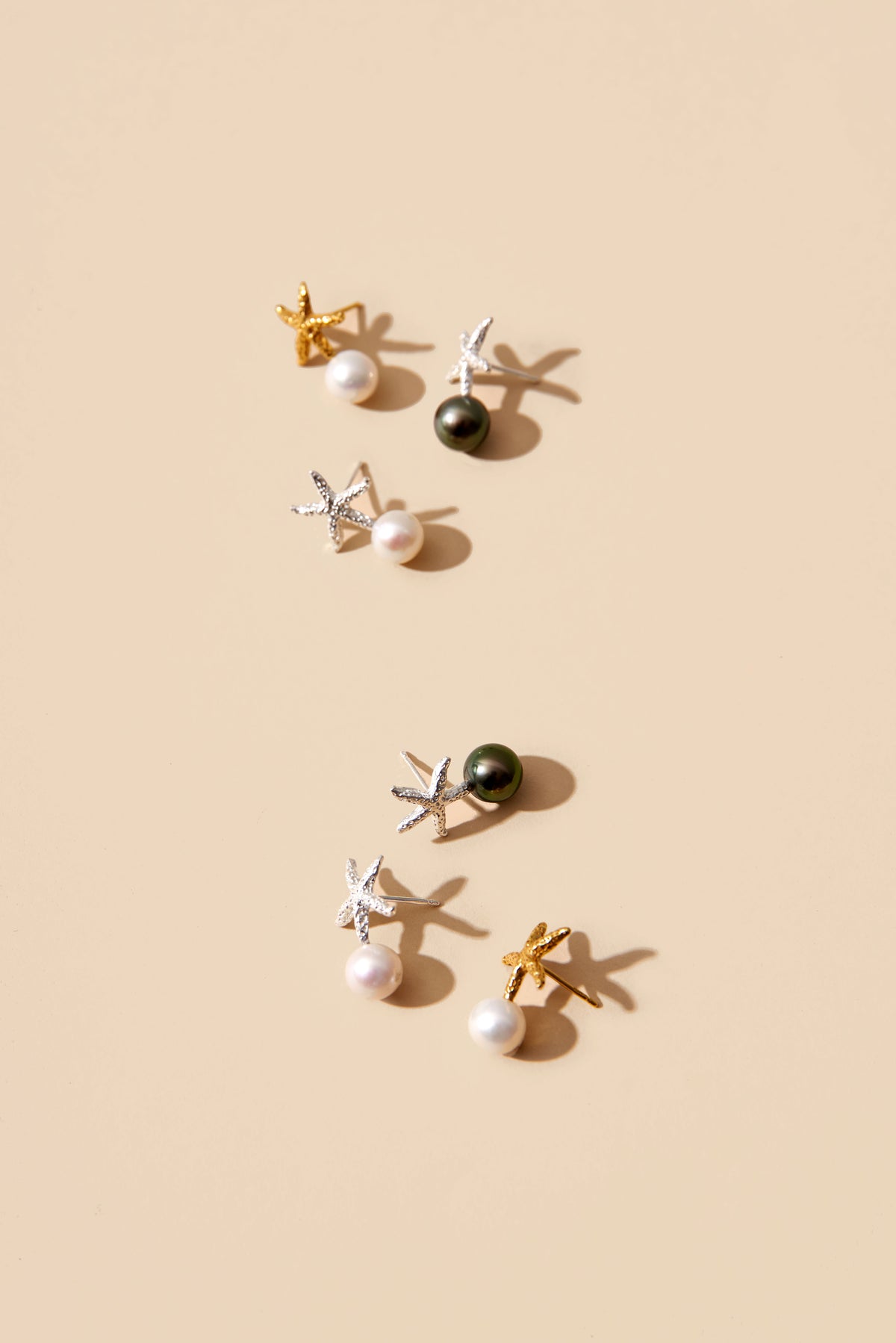 Oceano Jewels Ilot Starfish earrings with luminous white round freshwater pearls and tahitian pearl textured gold vermeil starfish.