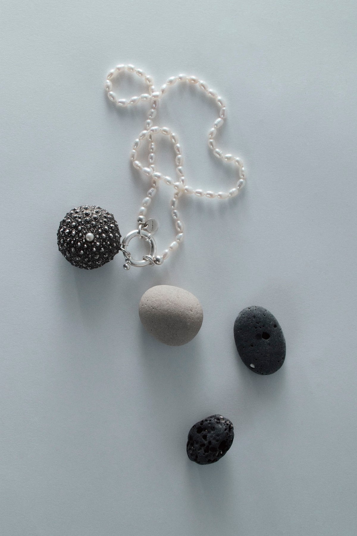 Surinam 70cm sterling silver necklace with freshwater white rice pearls and sculptural sea urchin oxidised pendant.