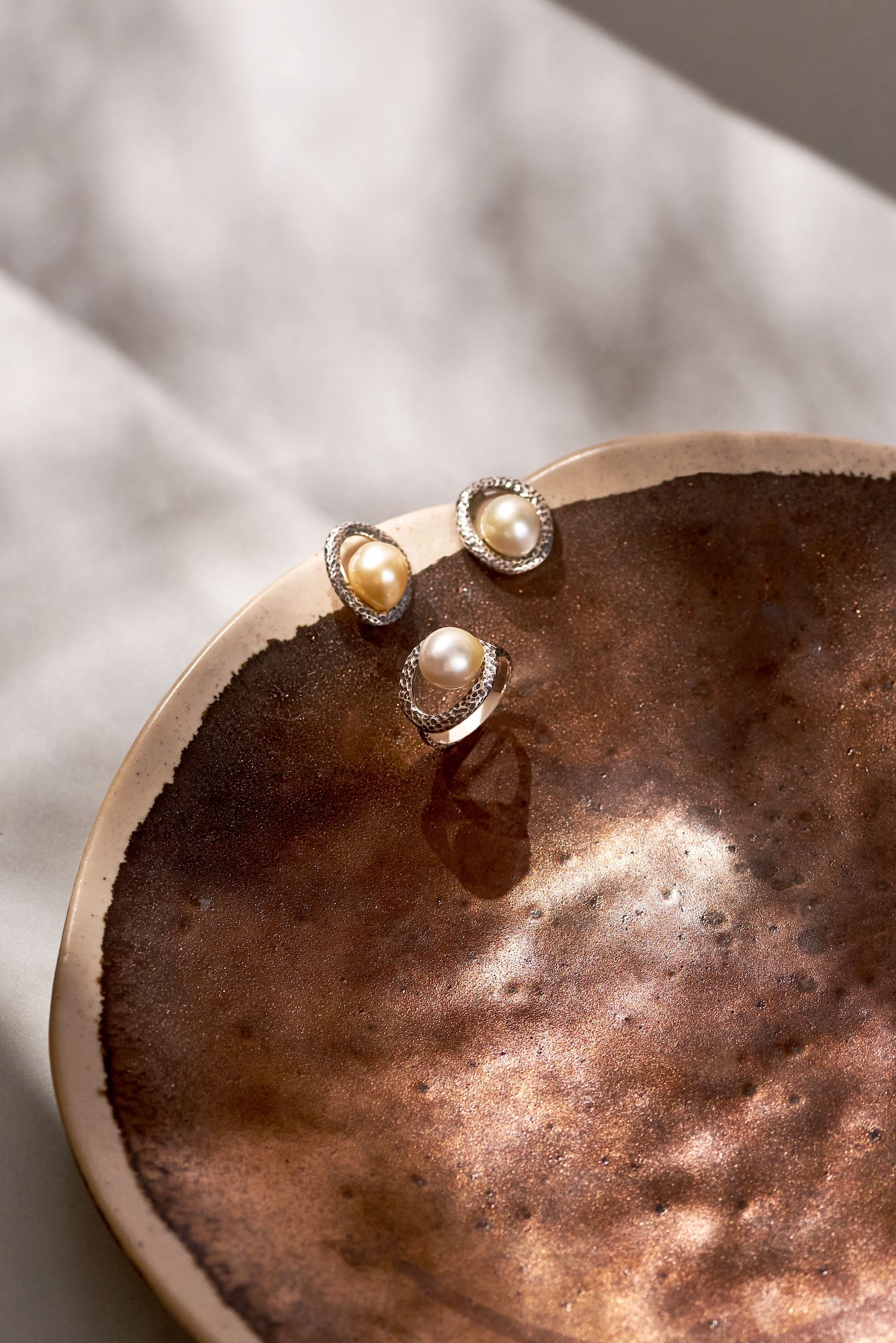 Close-up of Pamplemousse sterling silver ring featuring a luminous 10mm Golden South Sea pearl