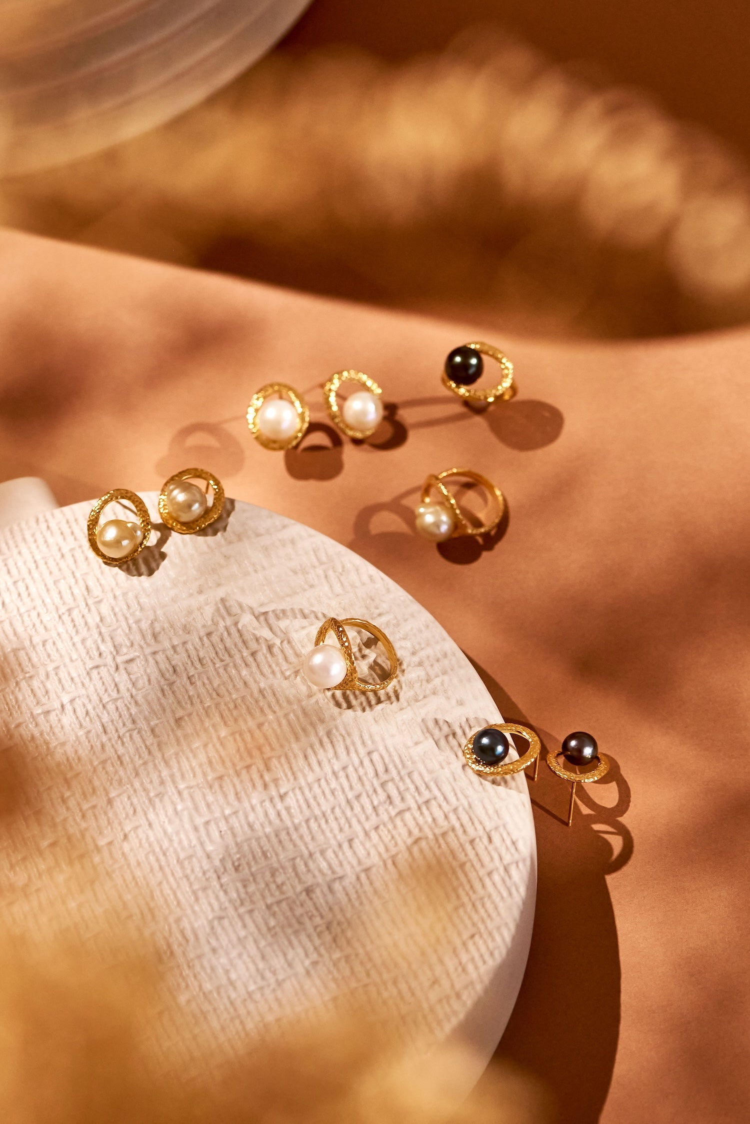Pamplemousse gold beaten earrings and rings with 10mm white South Sea pearls by Oceano Jewels
