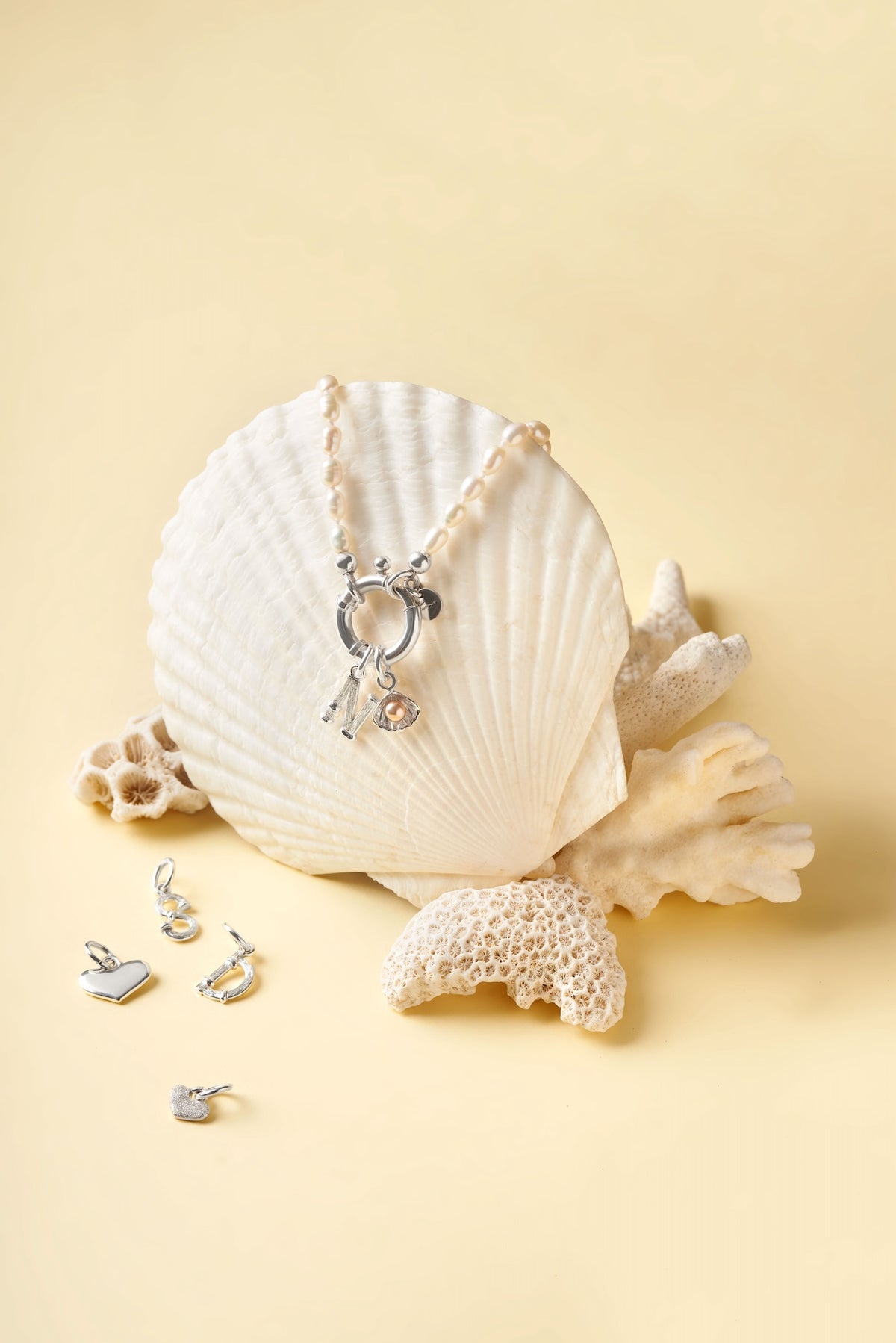 Surinam silver pearl necklace styled with seashells and ocean-inspired charms