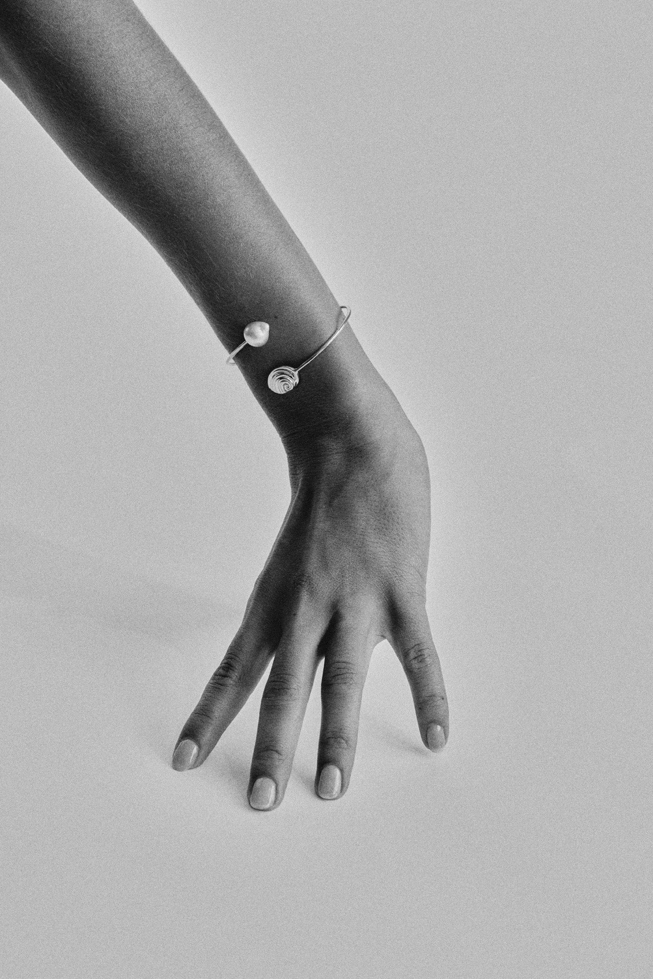 Trou D'eau Douce gold bracelet with baroque  pearl and spiral shell detail