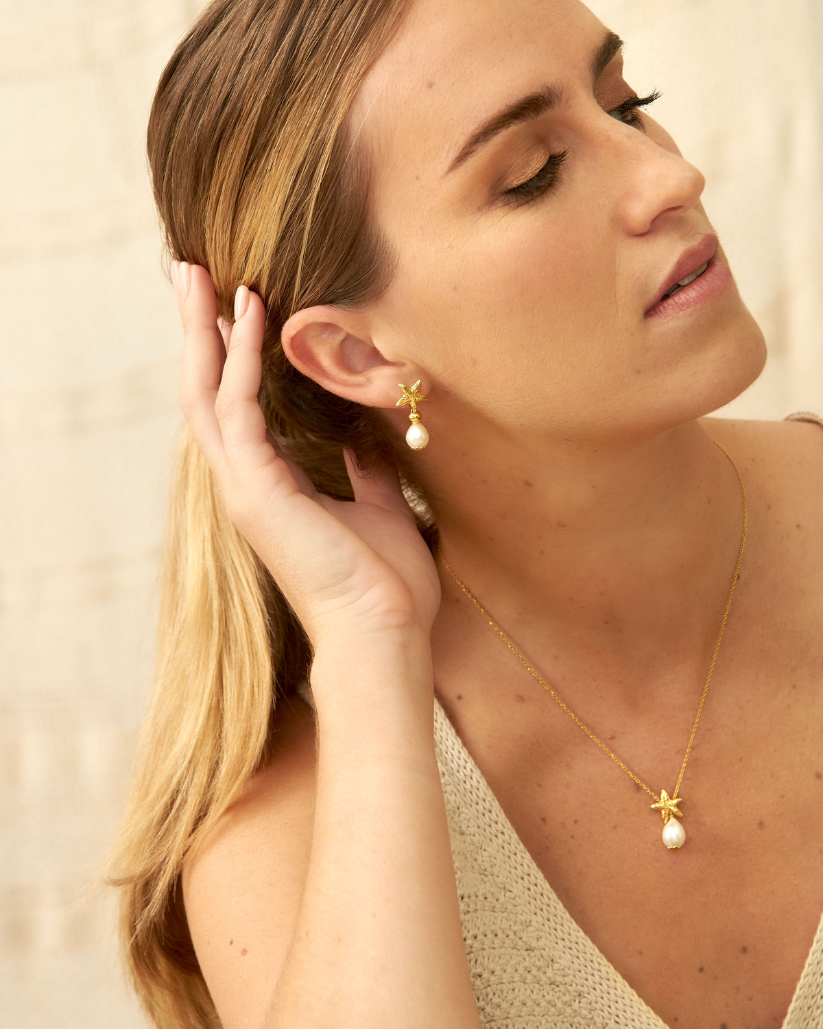 Belle Etoile gold jewellery detail with white drop pearl