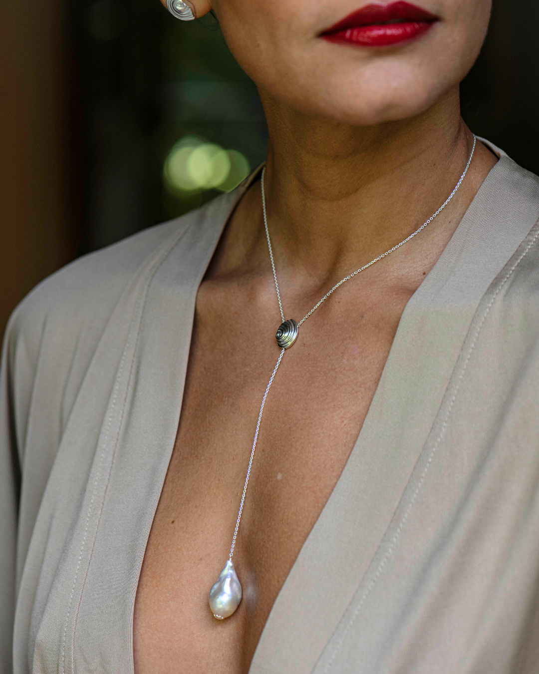 Handcrafted 925 sterling silver spiral shell necklace with freshwater pearl, made by Oceano Jewels in Mauritius