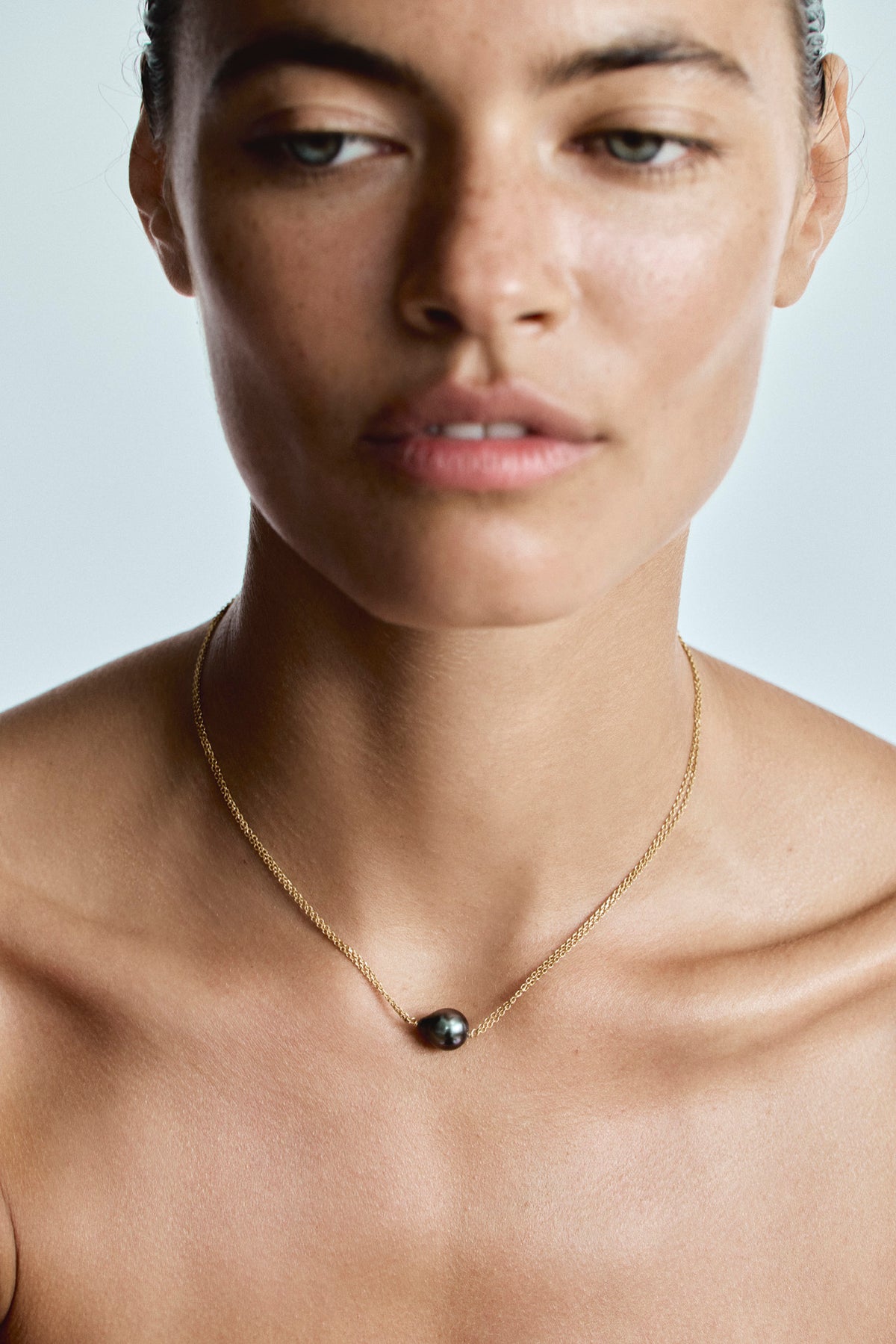 Close-up of natural Tahitian semi-round pearl 9–11 mm on Helvetia 18K gold necklace