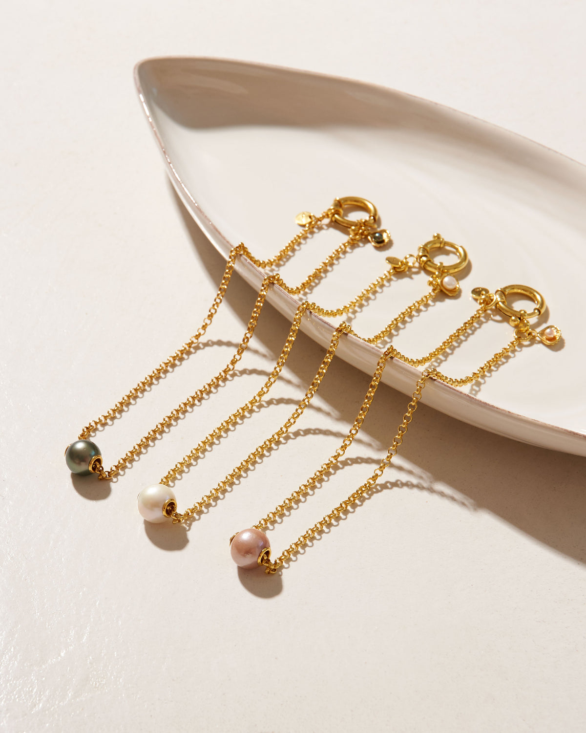Close-up detail of Paul et Virginie gold jewellery with white pearl handmade in Mauritiu