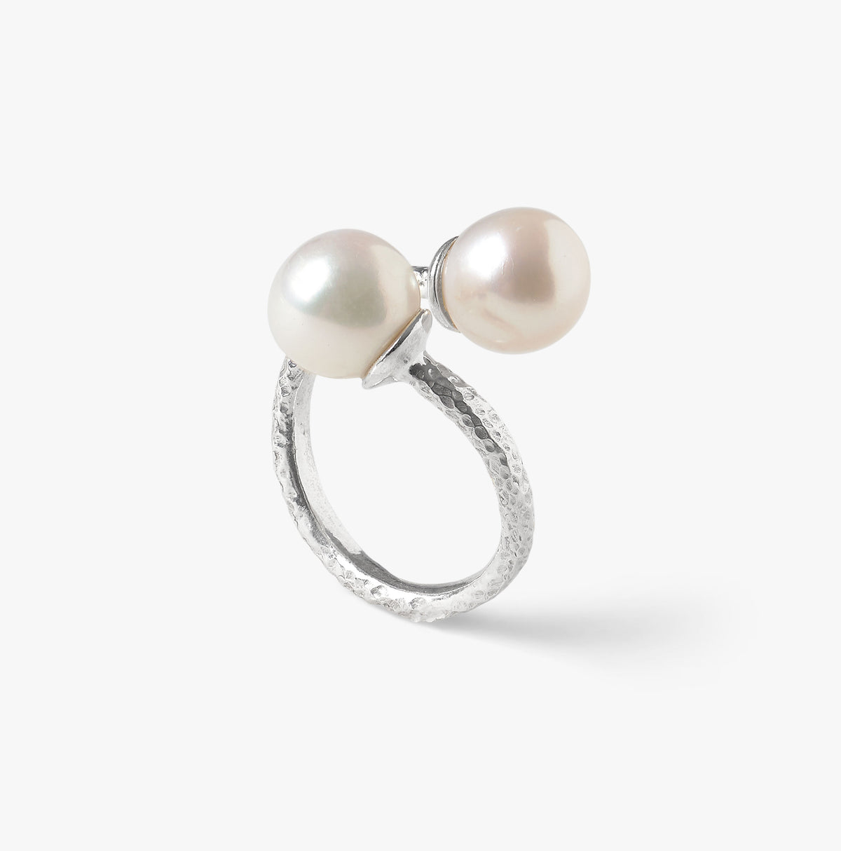Detail of two 10mm white freshwater pearls set on a handcrafted Trou d'Eau Douce sterling silver ring